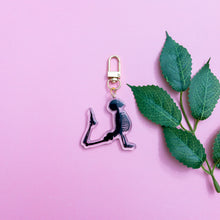 Load image into Gallery viewer,  attached to a gold polished swivel clasp. The background is a plain pink with a leaf branch prop
