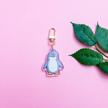 Load image into Gallery viewer, This is a cute penguin Keychain with a gold polished swivel clasp on a plain pink background
