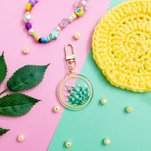 Load image into Gallery viewer, This is a Daisy Embroidery Hoop Keychain with a gold polished swivel clasp
