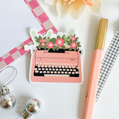 Retro style pink typewriter with flowers sticker 